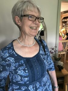 Craft group member wearing the necklace they made