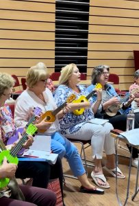 Ladies trying the ukulele 